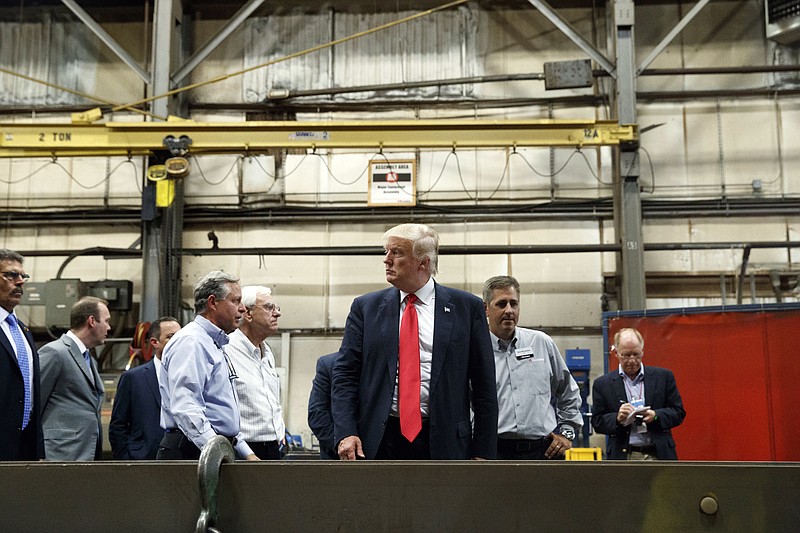 
              In this Friday, Aug. 12, 2016, photo, Republican presidential candidate Donald Trump takes a tour of McLanahan Corporation headquarters, a company that manufactures mineral and agricultural equipment in Hollidaysburg, Pa. On a Road to 270 that increasingly looks to be uphill climbs and dead ends for Trump in the nation’s usual collection of battleground states, the Republican presidential nominee needs a place to reset his Electoral College map. His stops this past week in Michigan and Pennsylvania suggest he’s looking at the industrial heartland states on the Great Lakes, a part of the country where he’s said he can compete with the Democratic nominee.  (AP Photo/Evan Vucci)
            
