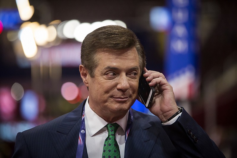 Paul Manafort, Donald Trump's campaign chairman, talks on his phone as preparations were made for the Republican National Convention in Cleveland during July. How Manafort may have benefited from powerful interests in the Ukraine are now under scrutiny. (Eric Thayer/The New York Times)