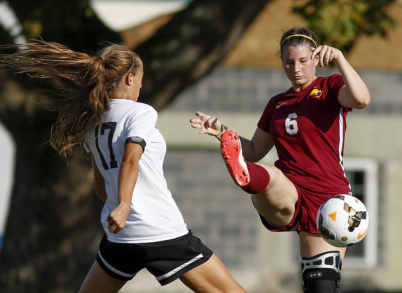 Grace Academy's Kaylee Godsey (6) takes a shot on the goal around Bradley Central's Anna Stouffer during their soccer match at Bradley Central High School on Tuesday, Aug. 16, 2016, in Cleveland, Tenn.