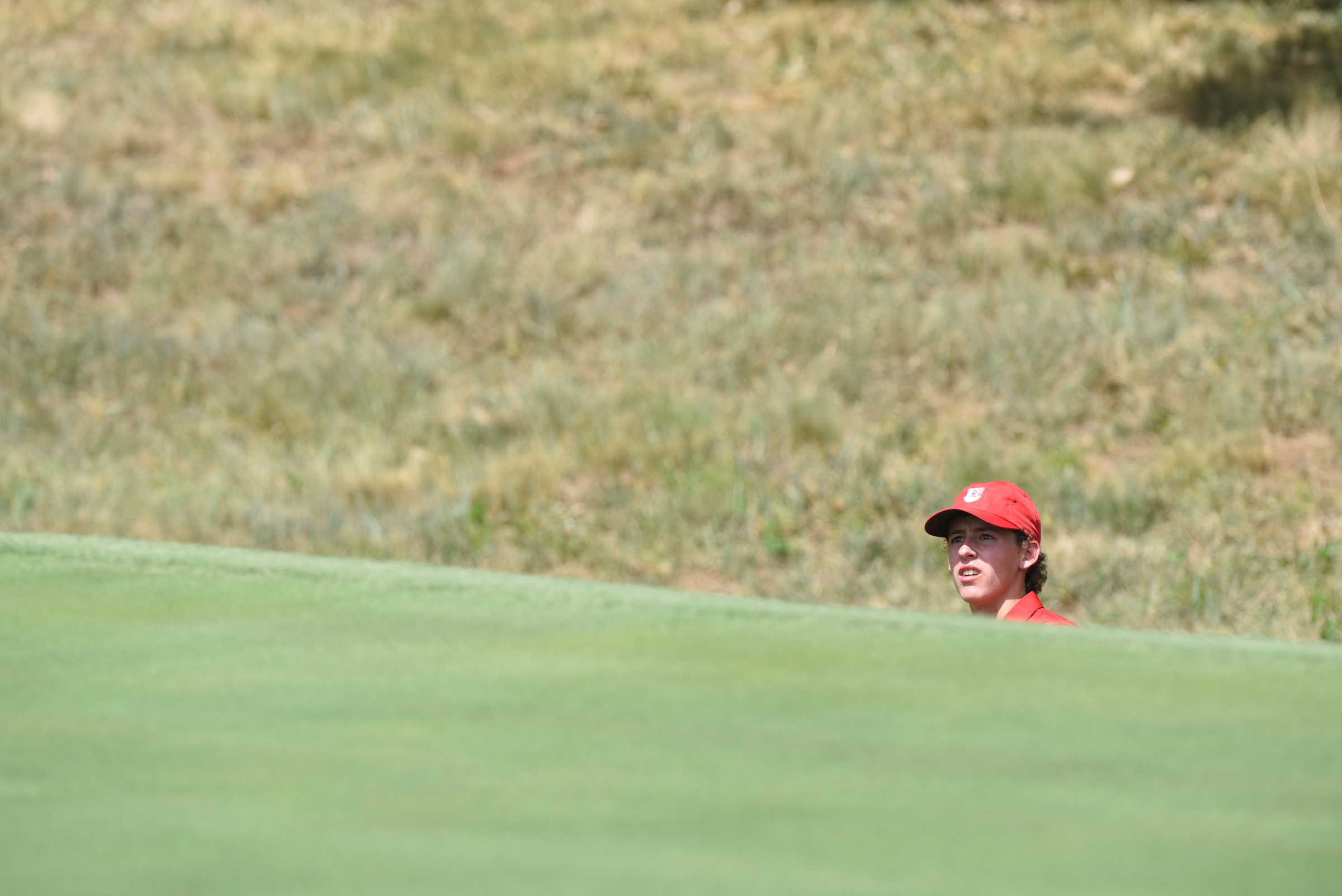 Baylor golfer Gavin Roberson looks at the pin from a green side bunker on No. 15 at Black Creek on Tuesday.