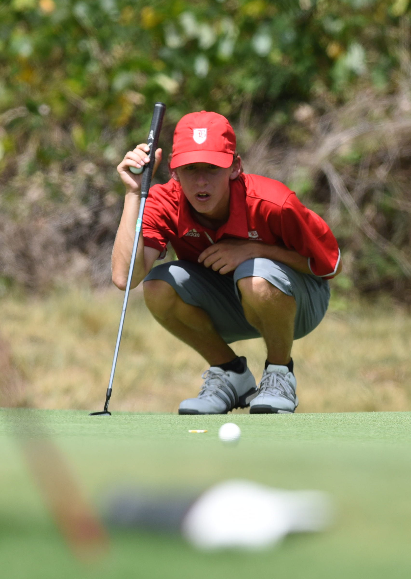Baylor golfer Gavin Roberson looks at the pin from a green side bunker on No. 15 at Black Creek on Tuesday.