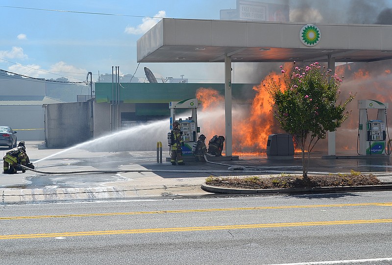 
              In this photo provided by Savannah Fire & Emergency Services, firefighters battle flames erupting from a gas station fuel pump in Savannah, Ga., Tuesday, Aug. 16, 2016. Authorities say an SUV lost control following a collision in the street and slammed into a fuel pump at a gas station along one of Savannah, Georgia's busiest roads, causing the pump to burst into flames and killing the driver. (Mark Keller/Savannah Fire and Emergency Services via AP)
            