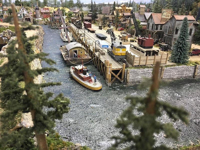 Model builder Willy Clonts created this tiny world from found materials ranging from wooden coffee stirrers to cigar bands. He painted the glassy surface of the mini-river with white caps and varied blues to resemble waves and water.