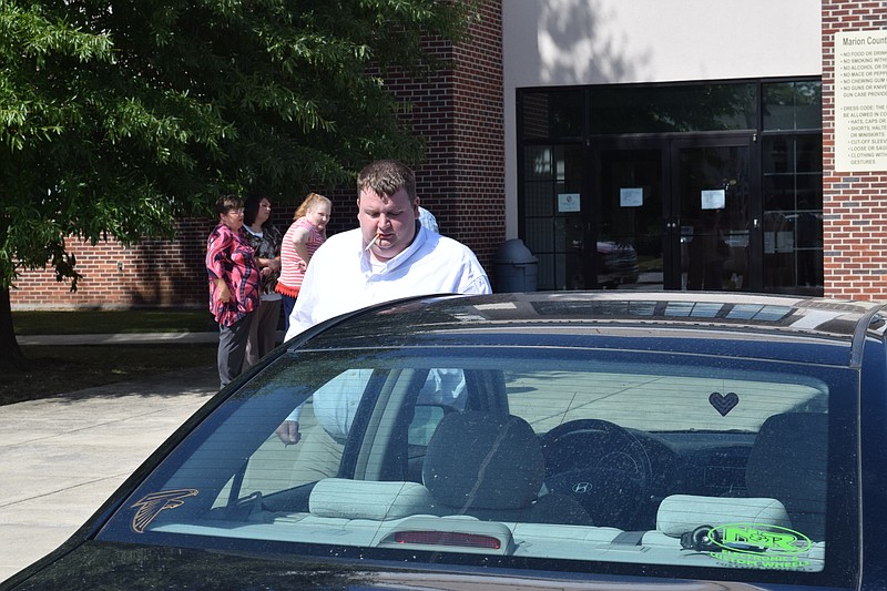 Christopher E. Russell, charged in Marion County, Tenn., in the June 2012 death of his 3-month-old son, Colin Eugene Russell, takes a break during his trial at the Marion County Justice Center.