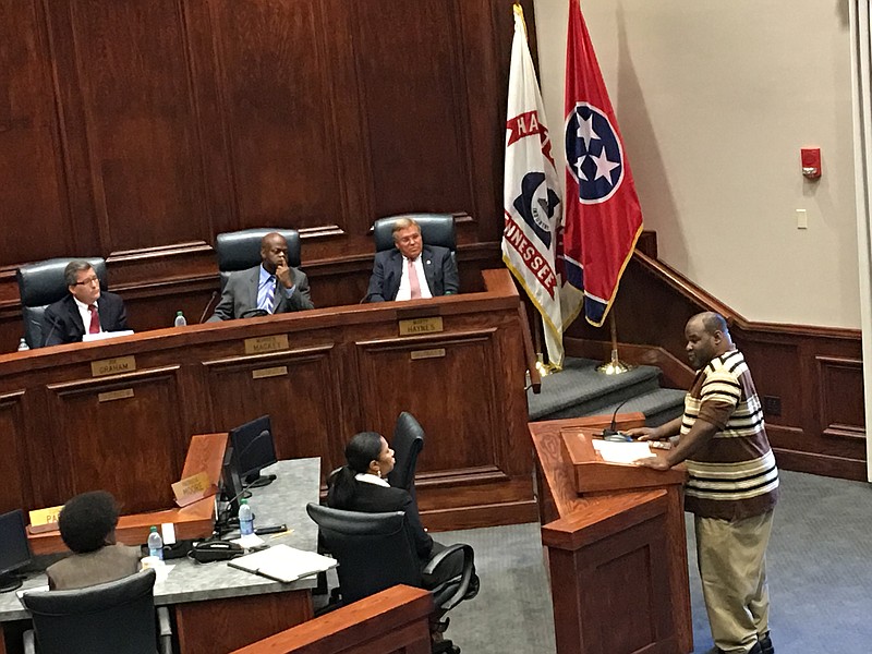 PHOTO BY PAUL LEACH. Chattanooga-Hamilton County NAACP representative Eric Atkins, right, addresses the Hamilton County Commission on Aug. 17. Seated are, from left, commissioners Joe Graham, Warren Mackey and Marty Haynes.