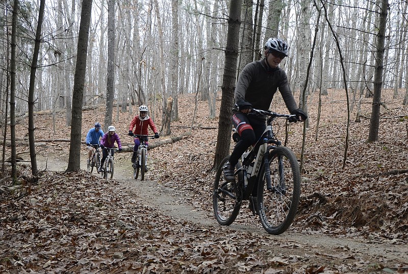 Bicyclers ride through the mountain biking trails at Enterprise South Nature Park.