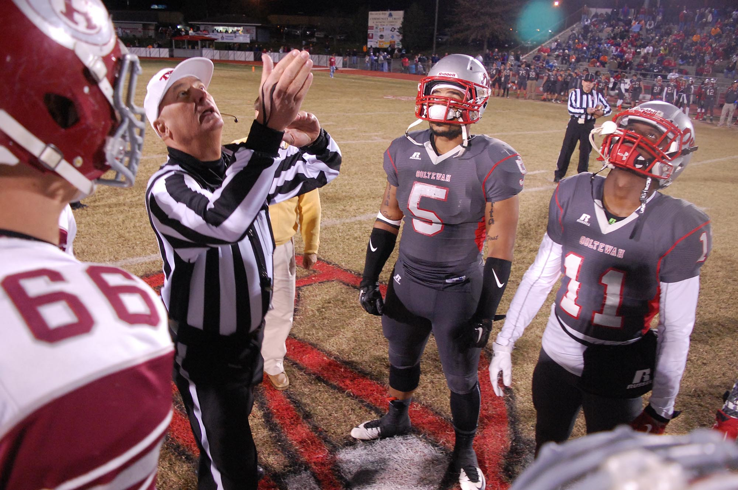 The team captains watch as the coin is tossed before the game. The Oak Ridge Wildcats visited the Ooltewah Owls in the second round of the TSSAA 5A football playoffs on Friday 13, 2015.