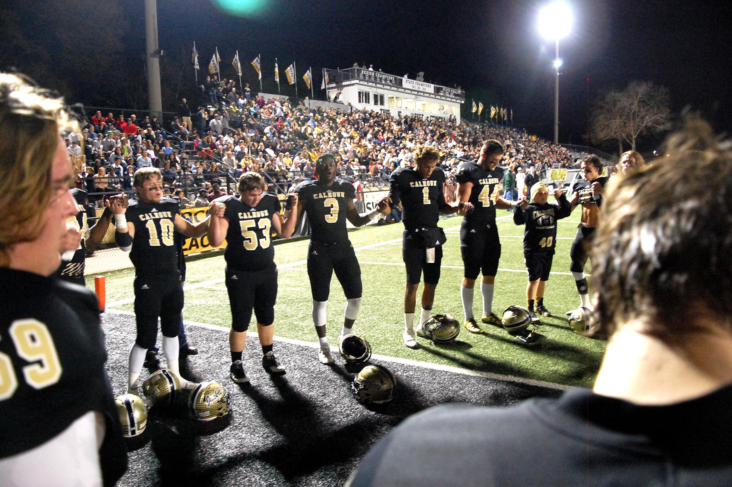 Some of the Yellow Jackets pray in the endzone after warming up. The Elbert County Blue Devils visited the Calhoun Yellow Jackets in a GHSA Football Playoff game on Friday November 27, 2015.
