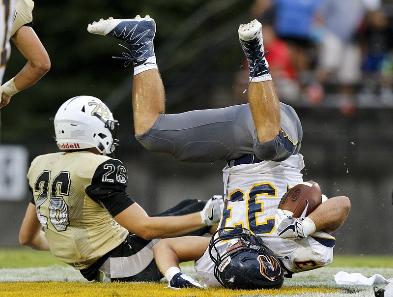 Bradley Central's Cason Still upends Walker Valley's Alex King (33) during their prep football game at Bradley Central High School on Thursday, Aug. 18, 2016, in Cleveland, Tenn.