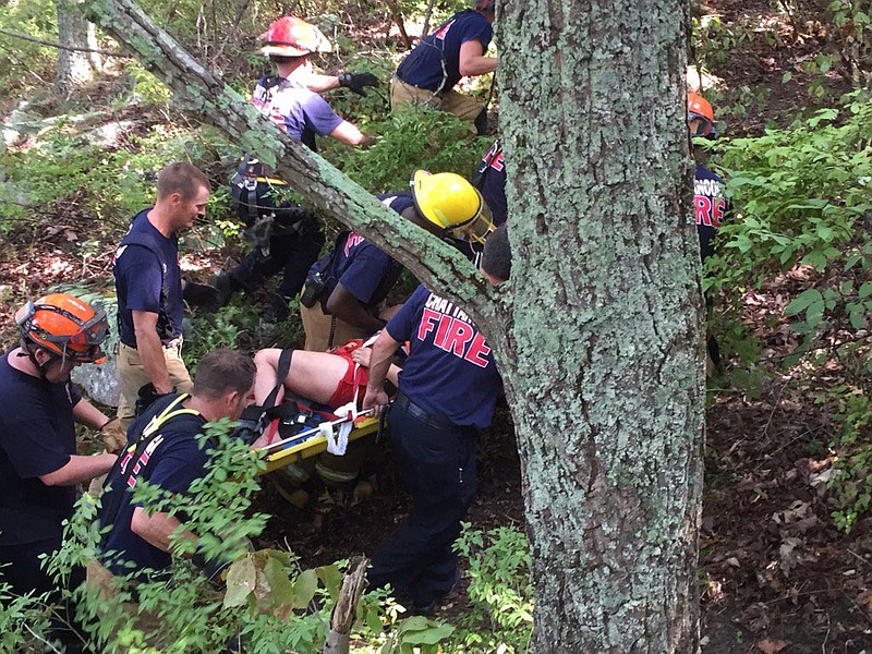 Rescuers pull a woman to safety after she fell from Raccoon Mountain. 