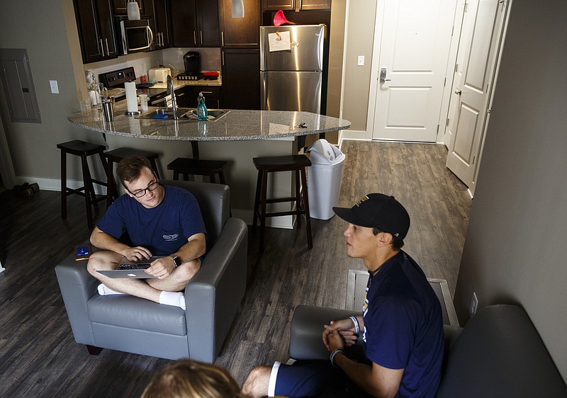 UTC students Ben Domning, left, and David Koulakov talk in the common area of their room in the new Douglas Heights apartment building Friday, Aug. 19, 2016, in Chattanooga, Tenn. Residents have already begun moving in to the apartment building, which caters to UTC students.