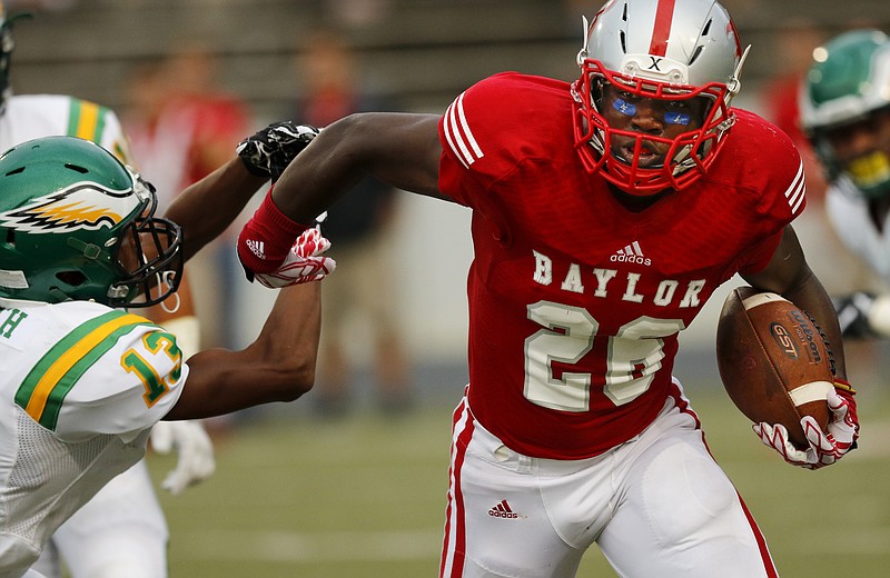 Baylor running back Kalvin Watson, right, stiff-arms Rhea County defensive back Aulbrey Smith during the Red Raiders' season-opening 35-0 win Friday night at Baylor.