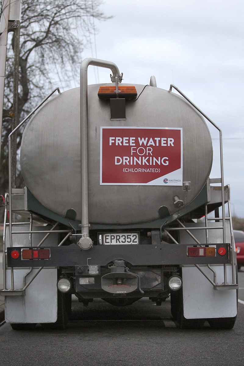 
              A Hastings District Council water tanker with free water is seen on Campbell St, in Havelock North, after a gastro outbreak in Havelock North, from the Hastings District Council water supply, Thursday, Aug. 18, 2016.  Tests in New Zealand confirmed an elderly woman who died last week was suffering from the type of bacteria that tainted local tap water and sickened thousands of people in the small North Island town, officials said Friday, Aug. 19. (Duncan Brown/New Zealand Herald via AP)
            