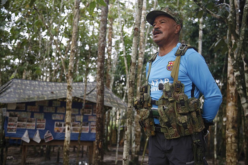 
              In this Wednesday, Aug. 17, 2016 photo, Martin Corena, acting commander of the Revolutionary Armed Forces of Colombia’s southern bloc, FARC, addresses his troops in the southern jungles of Putumayo, Colombia. Corena is calling on President Barack Obama to free a guerrilla leader jailed for more than a decade in the U.S. Corena said Ricardo Palmera’s 60-year sentence in connection to the FARC’s holding captive of three American defense contracts was incompatible with Obama’s support for a peace deal. (AP Photo/Fernando Vergara)
            