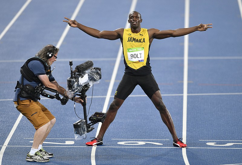 
              Usain Bolt from Jamaica celebrates winning the gold medal in the men's 200-meter final ahead during the athletics competitions of the 2016 Summer Olympics at the Olympic stadium in Rio de Janeiro, Brazil, Thursday, Aug. 18, 2016. (AP Photo/Martin Meissner)
            