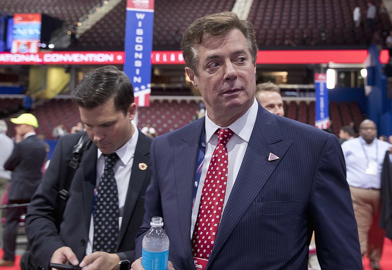 FILE - In this July 18, 2016, file photo, Trump campaign chairman Paul Manafort walks around the convention floor before the opening session of the Republican National Convention in Cleveland. Manafort resigned in wake of campaign shakeup and revelations about Ukraine work. (AP Photo/Carolyn Kaster, File)