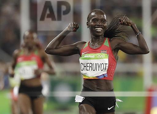 Kenya's Vivian Jepkemoi Cheruiyot celebrates winning the gold medal and setting a new Olympic record in the women's 5000-meter final during the athletics competitions of the 2016 Summer Olympics at the Olympic stadium in Rio de Janeiro, Brazil, Friday, Aug. 19, 2016. (AP Photo/David J. Phillip)