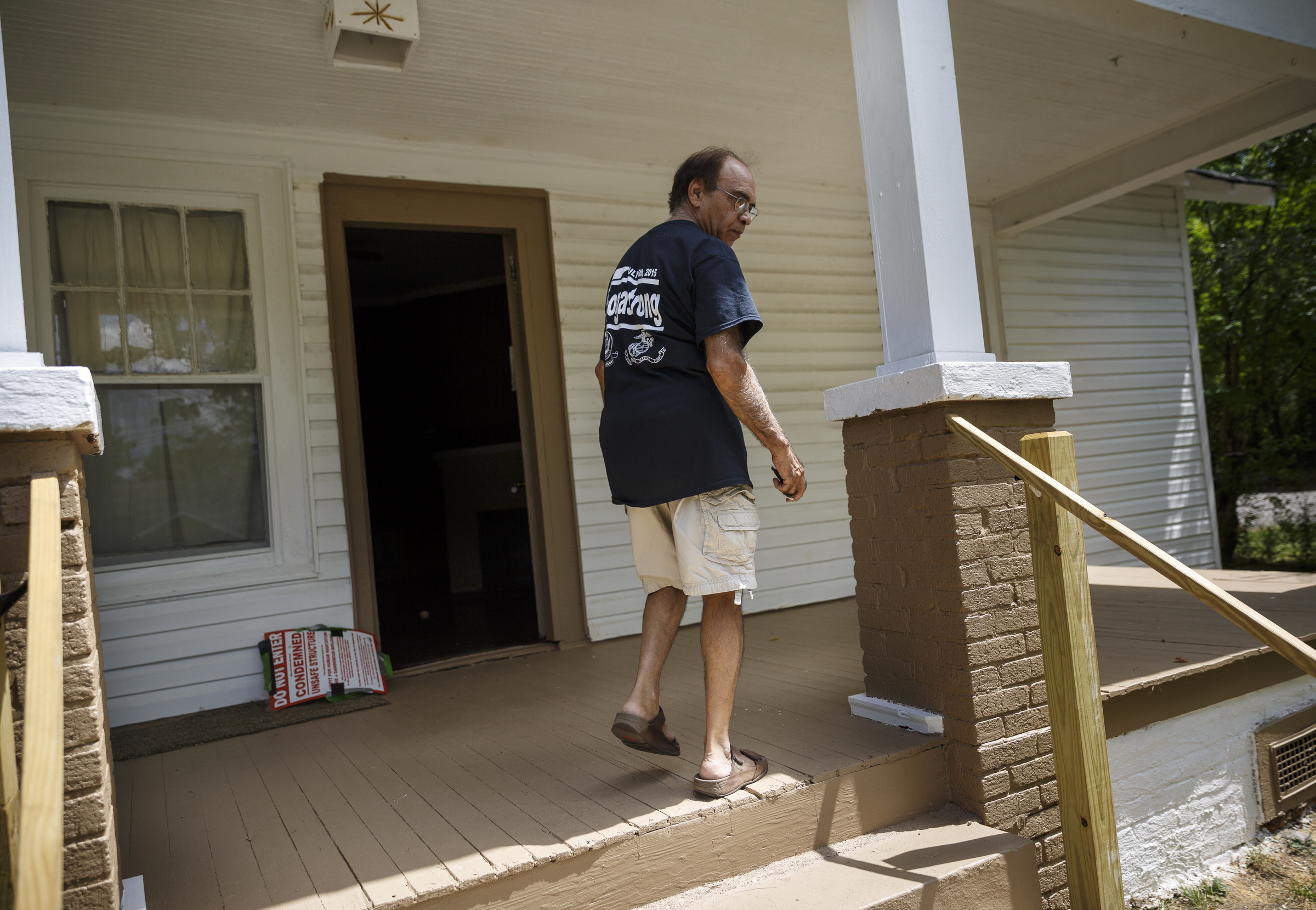 Landlord Ron Bhalla walks up the stairs to one of his properties in East Chattanooga that was recently brought back to code after being condemned by city codes inspectors on Thursday, Aug. 11, 2016, in Chattanooga, Tenn. Some area landlords are speaking out against codes inspectors, who they say use unfair practices in condemning properties.