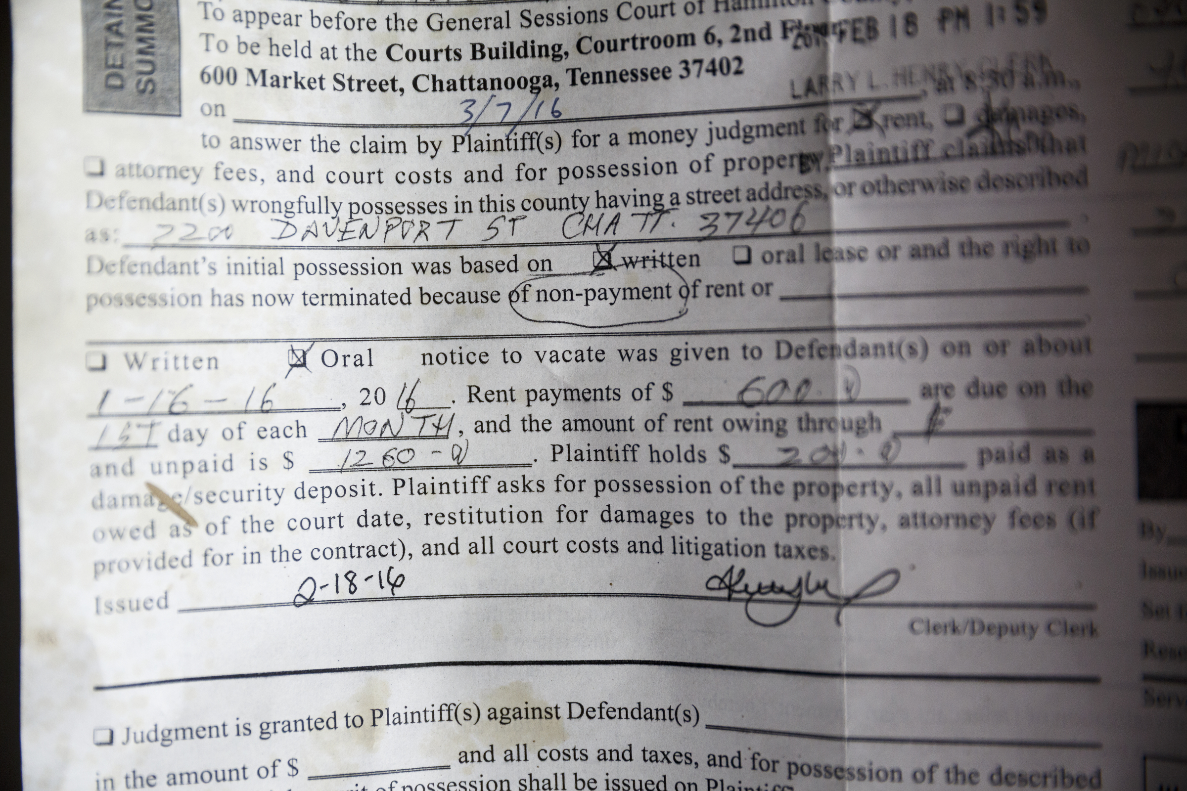 An old sessions court summons notifying a tenant of eviction remains on the door of one of landlord Ron Bhalla's properties in East Chattanooga that was recently brought back to code after being condemned by city codes inspectors on Thursday, Aug. 11, 2016, in Chattanooga, Tenn. Some area landlords are speaking out against codes inspectors, who they say use unfair practices in condemning properties.