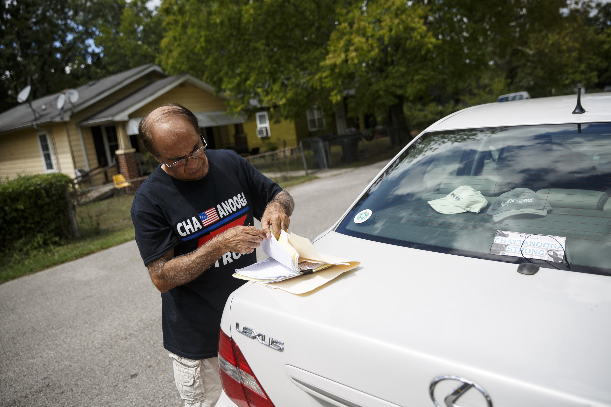 Landlord Ron Bhalla looks through documents for a codes enforcement document about one of his properties in East Chattanooga that was recently brought back to code after being condemned by city codes inspectors on Thursday, Aug. 11, 2016, in Chattanooga, Tenn. Some area landlords are speaking out against codes inspectors, who they say use unfair practices in condemning properties.