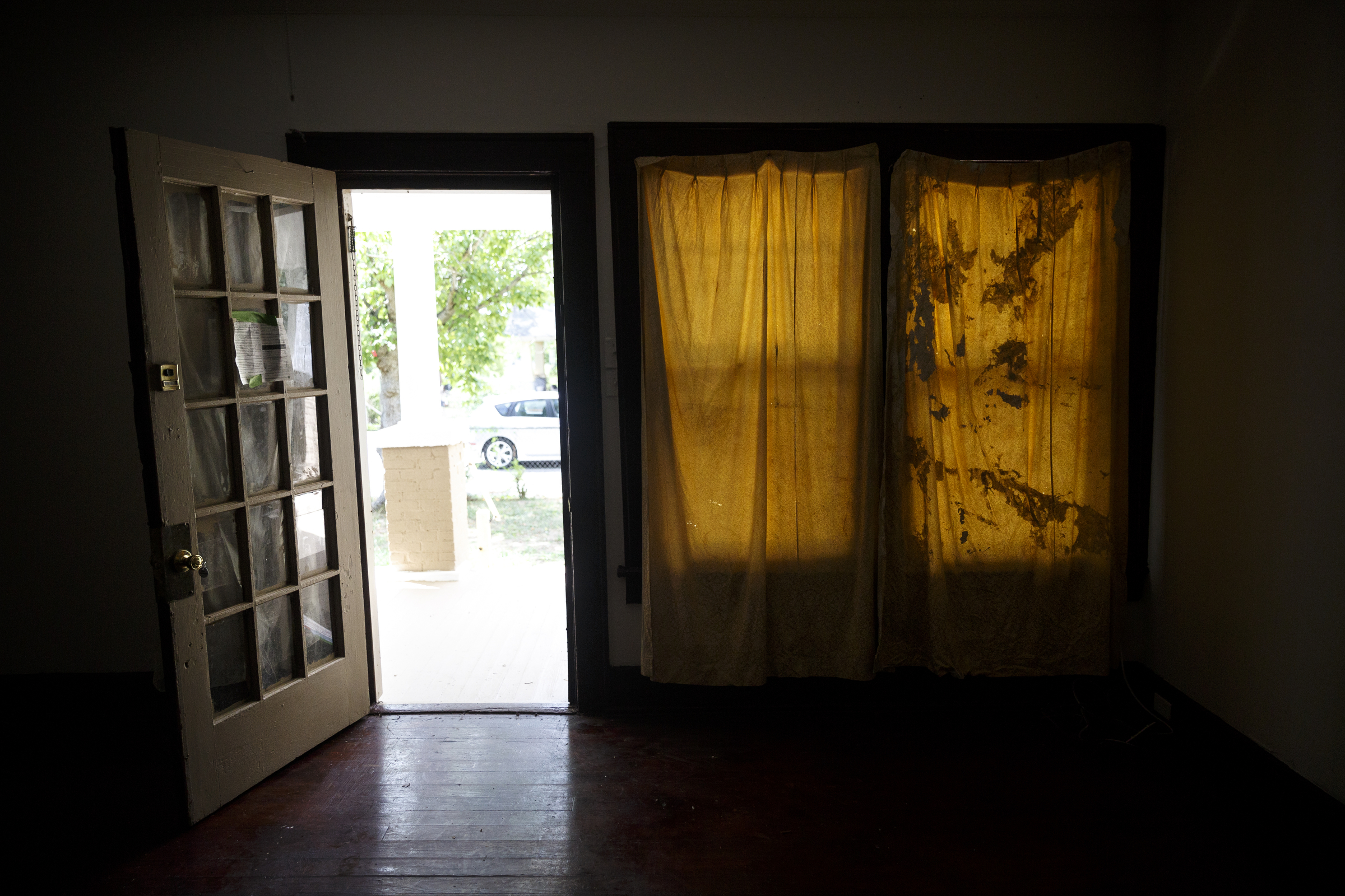 Curtains cover a window in one of landlord Ron Bhalla's properties in East Chattanooga that was recently brought back to code after being condemned by city codes inspectors on Thursday, Aug. 11, 2016, in Chattanooga, Tenn. Some area landlords are speaking out against codes inspectors, who they say use unfair practices in condemning properties.