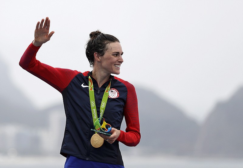 
              Gwen Jorgensen, of the United States, waves after receiving the gold medal for winning the women's triathlon event on Copacabana beach at the 2016 Summer Olympics in Rio de Janeiro, Brazil, Saturday, Aug. 20, 2016. (AP Photo/David Goldman)
            
