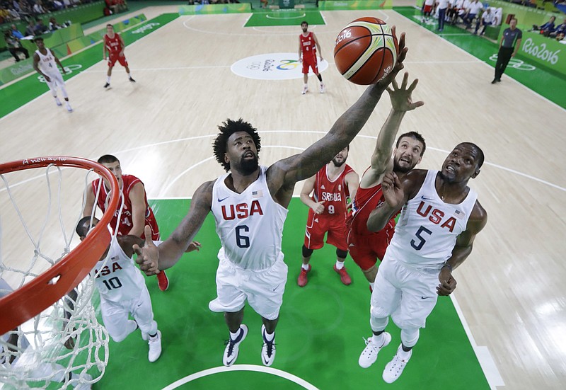 In this Aug. 12, 2016, file photo, United States' DeAndre Jordan (6), Kevin Durant (5) and Serbia's Stefan Bircevic, center, reach for a rebound during a men's basketball game at the 2016 Summer Olympics in Rio de Janeiro, Brazil. The United States plays Serbia on Sunday, Aug. 21 for the gold medal. The U.S. won 94-91 in pool play against Serbia. (AP Photo/Eric Gay, File)