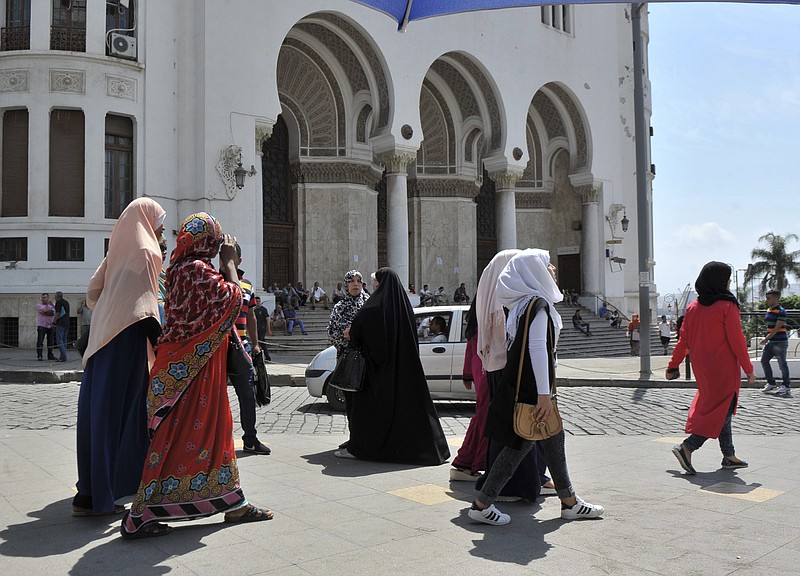 
              Veiled women walk in central Algiers, Wednesday Aug. 10, 2016.  Mosques are going up, women are covering up and bars, restaurants and shops selling alcoholic beverages are shutting down in a changing Algeria where, slowly but surely, Muslim fundamentalists are gaining ground.(AP Photo/Ouahab Hebbat)
            