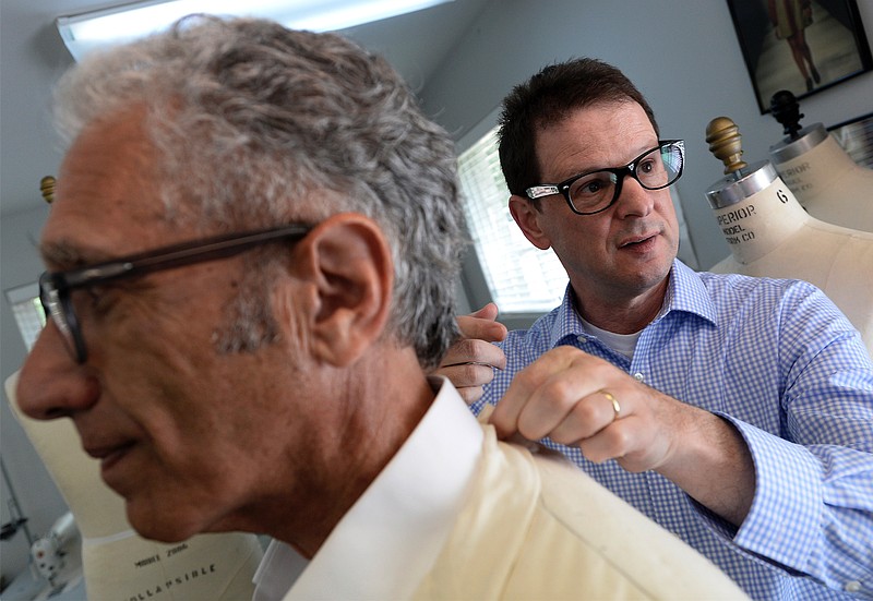 
              Assistant Professor of Fashion Design Kevin Crouch makes sure a muslin mock-up seersucker sport jacket fits correctly on the shoulders of O'More College of Design President David Rosen during a fitting on Tuesday, August 9, 2016, in Franklin, Tenn.   (Ricky Rogers/The Tennessean via AP)
            