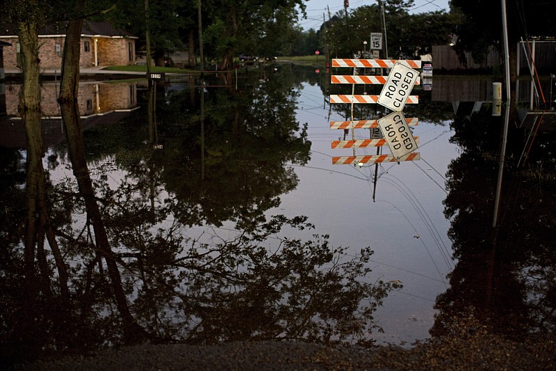 
              Standing water closes roads in Sorrento, La., Saturday, Aug. 20, 2016.  Louisiana continues to dig itself out from devastating floods, with search parties going door to door looking for survivors or bodies trapped by flooding.  (AP Photo/Max Becherer)
            