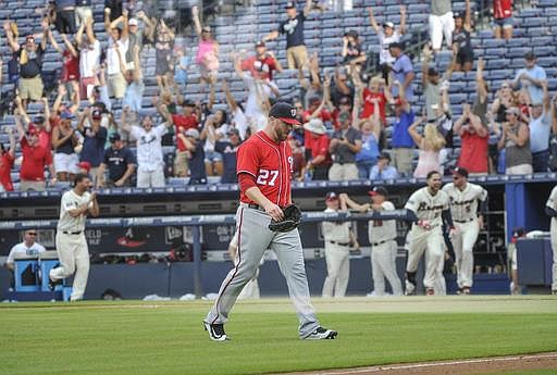 Washington Nationals pitcher Shawn Kelley walks off the field as the walk off home run ball of Atlanta Braves' Jace Peterson sails to the right field wall during the tenth inning of a baseball game, Sunday, Aug. 21, 2016, in Atlanta. Atlanta won 7-6. (AP Photo/John Amis)