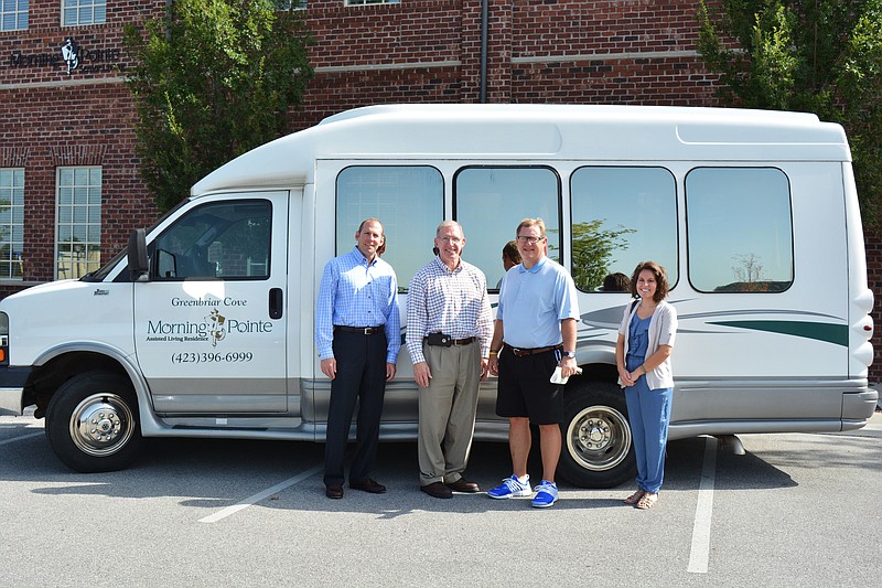 Morning Pointe officials present the keys to a 15-person passenger van to Bachman Academy Headmaster Mark Frizzell and Executive Assistant Emilee Farris.