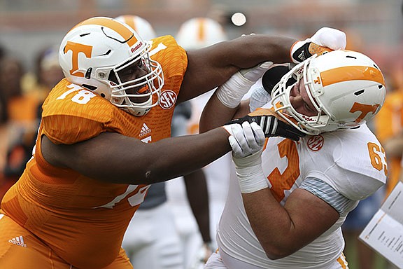 Staff Photo by Dan Henry / The Chattanooga Times Free Press- 4/25/15. The University of Tennessee's Charles Mosley (78) collides with Brett Kendrick (63) during the Dish Orange & White Game in Knoxville on Saturday, April 25, 2015.