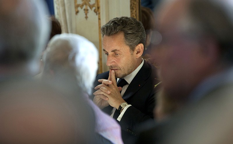 
              FILE - This March 27, 2013 file photo shows former French President Nicolas Sarkozy, center, waiting for his turn to speak during a medal ceremony at the Egmont Palace in Brussels, Belgium. France’s conservative former President Nicolas Sarkozy has formally announced he is running again to become French president in next year's elections. (AP Photo/Virginia Mayo, File)
            