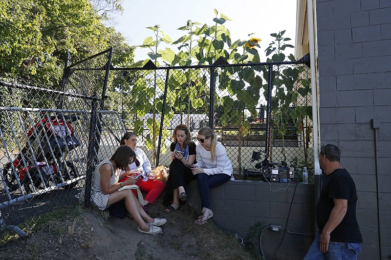 Reporters gather at chain link fence corner of a parking trying to hear Democratic presidential candidate Hillary Clinton's remarks to a crowd of about 1,000 supporters during a fundraiser at the Pilgrim Monument and Provincetown Museum in Provincetown, Mass., Sunday, Aug. 21, 2016. The Democratic nominee hold all of her fundraisers behind closed doors, leaving voters in the dark about what she's telling some of her most influential supporters. (AP Photo/Carolyn Kaster)