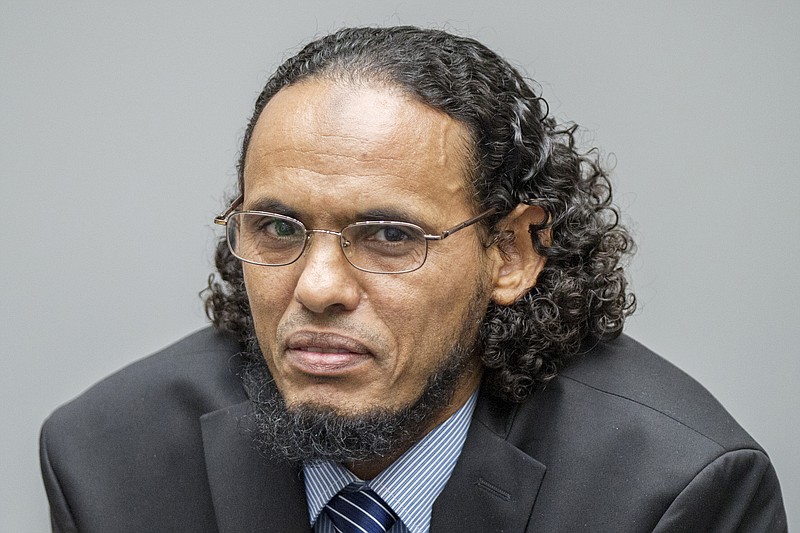 
              Ahmad Al Faqi Al Mahdi appears at the International Criminal Court in The Hague, Netherlands, Monday, Aug. 22, 2016, at the start of his trial on charges of involvement in the destruction of historic mausoleums in the Malian desert city of Timbuktu. Prosecutors allege that Al Mahdi was a member of an al Qaida-linked occupying force that destroyed most of Timbuktu's World Heritage-listed mausoleums in 2012. (AP Photo/Patrick Post, Pool)
            