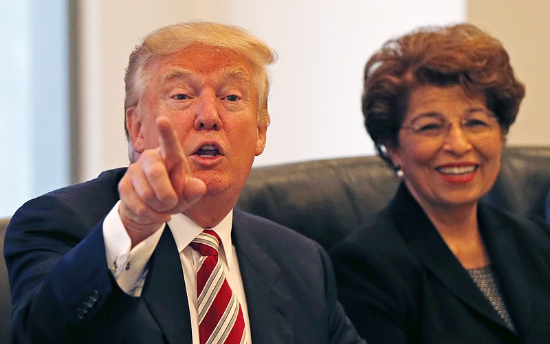 
              Republican presidential candidate Donald Trump holds a Hispanic advisory roundtable meeting in New York, Saturday, Aug. 20, 2016. At right is Jovita Carranza, former Small Business Administration Deputy Administrator. (AP Photo/Gerald Herbert)
            