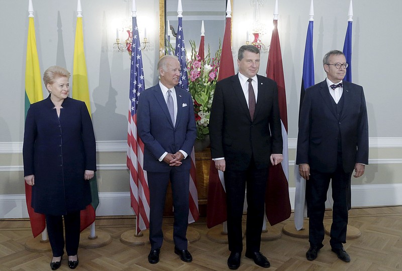 
              From left: Lithuanian President Dalia Grybauskaite, U.S. Vice President Joe Biden, Latvian President Raimonds Vejonis and Estonian President Toomas Hendrik Ilves pose for a photo during a press conference after their meeting in Riga, Latvia, Tuesday, Aug. 23, 2016. Biden has reaffirmed America's commitment to defending the Baltic nations of Latvia, Lithuania and Estonia against any threat from neighboring Russia. (Latvian Presidential Press Service Photo via AP)
            