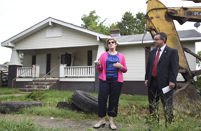 Chattanooga Neighborhood Enterprise President and CEO Martina Guilfoil, left, and Ralph Perrey, executive director of the Tennessee Housing Development Agency, speak before demolition begins Tuesday, August 23, 2016 at 1801 E. 12th Street. The abandoned home will be demolished to make way for new affordable housing.
