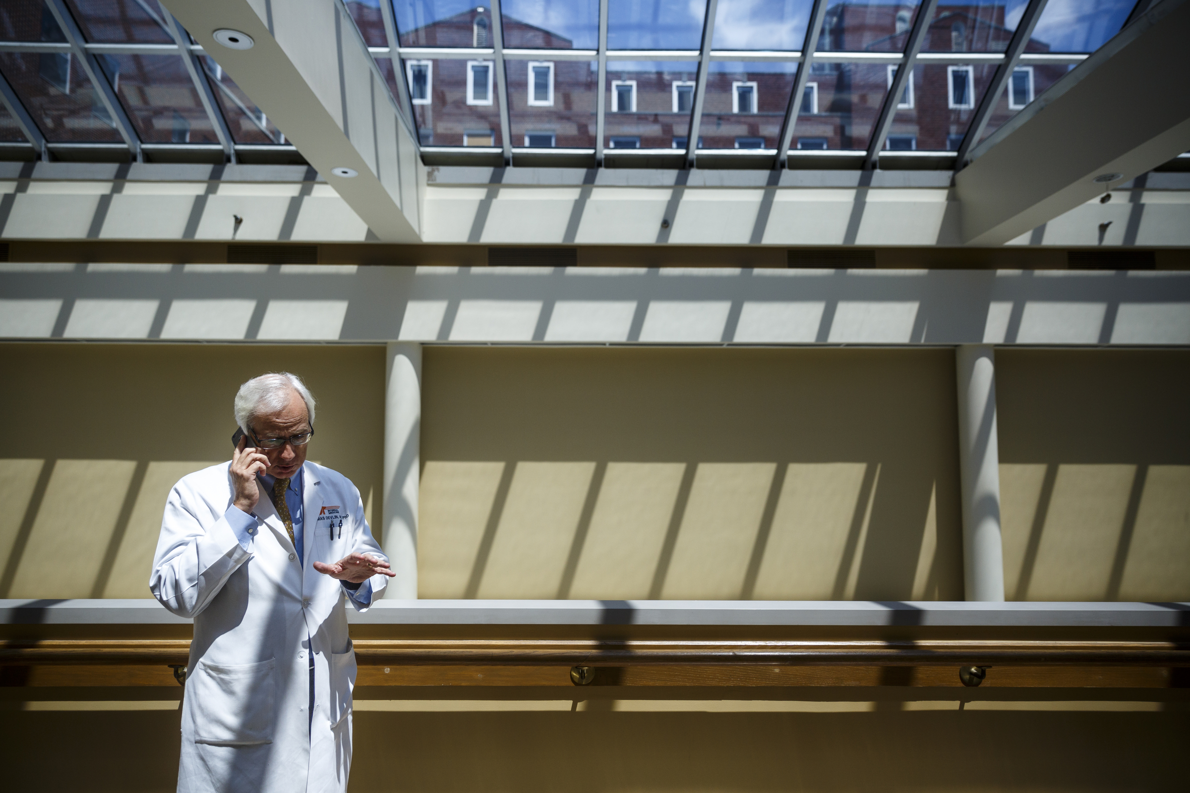 Dr. Thomas Devlin talks on the phone in the hallway on his way to view a patient's diffusion MRI at Erlanger Hospital on Tuesday, Aug. 23, 2016, in Chattanooga, Tenn. Dr. Devlin is leading a clinical trial involving injecting stem cells into the brains of stroke victims.