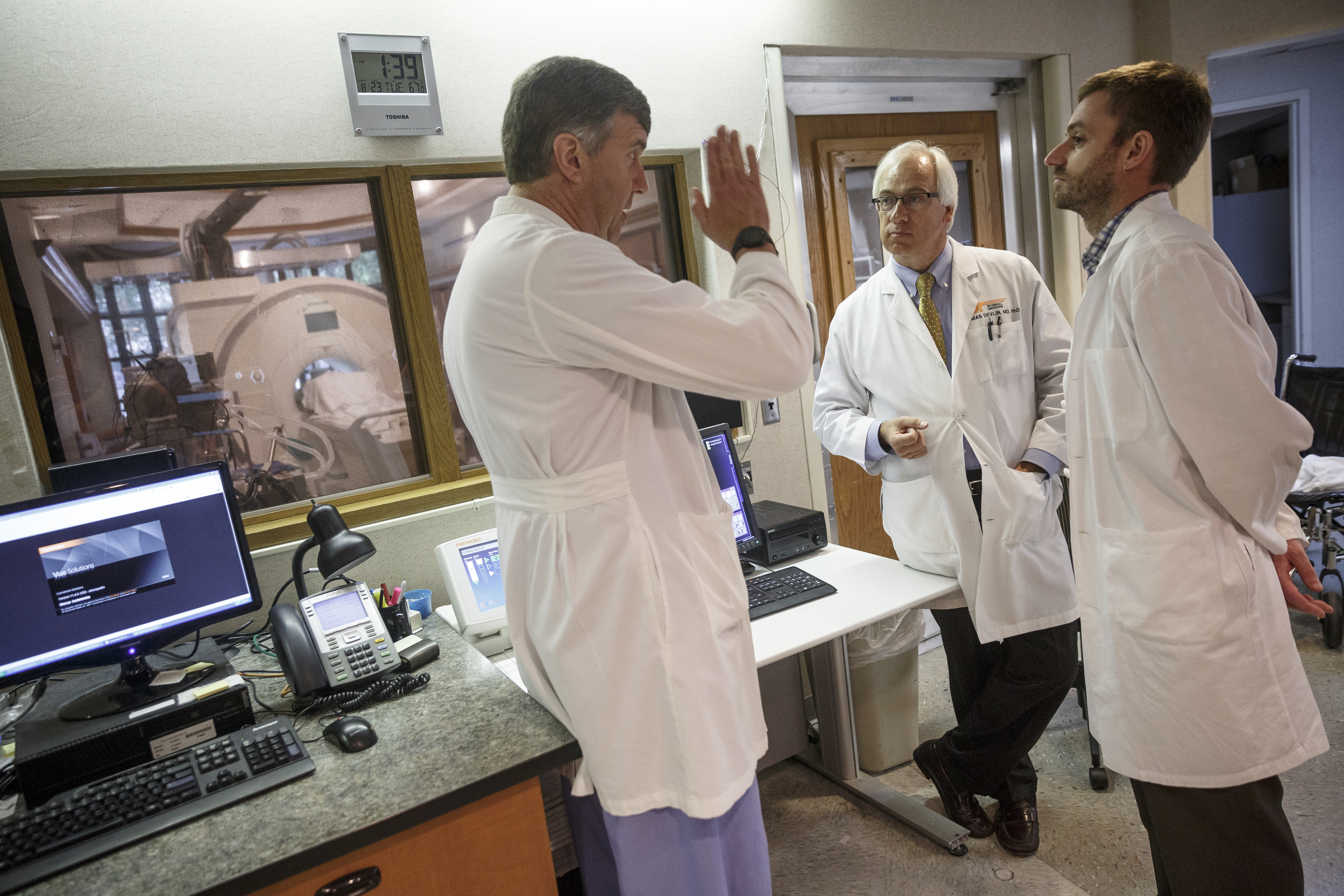 Dr. Thomas Devlin, center, talks with colleagues Dr. Brett Jennings, right, and Dr. Michael Gallagher about a patient's diffusion MRI and their possibility as a candidate for a clinical trial at Erlanger Hospital on Tuesday, Aug. 23, 2016, in Chattanooga, Tenn. Dr. Devlin is leading a clinical trial involving injecting stem cells into the brains of stroke victims.