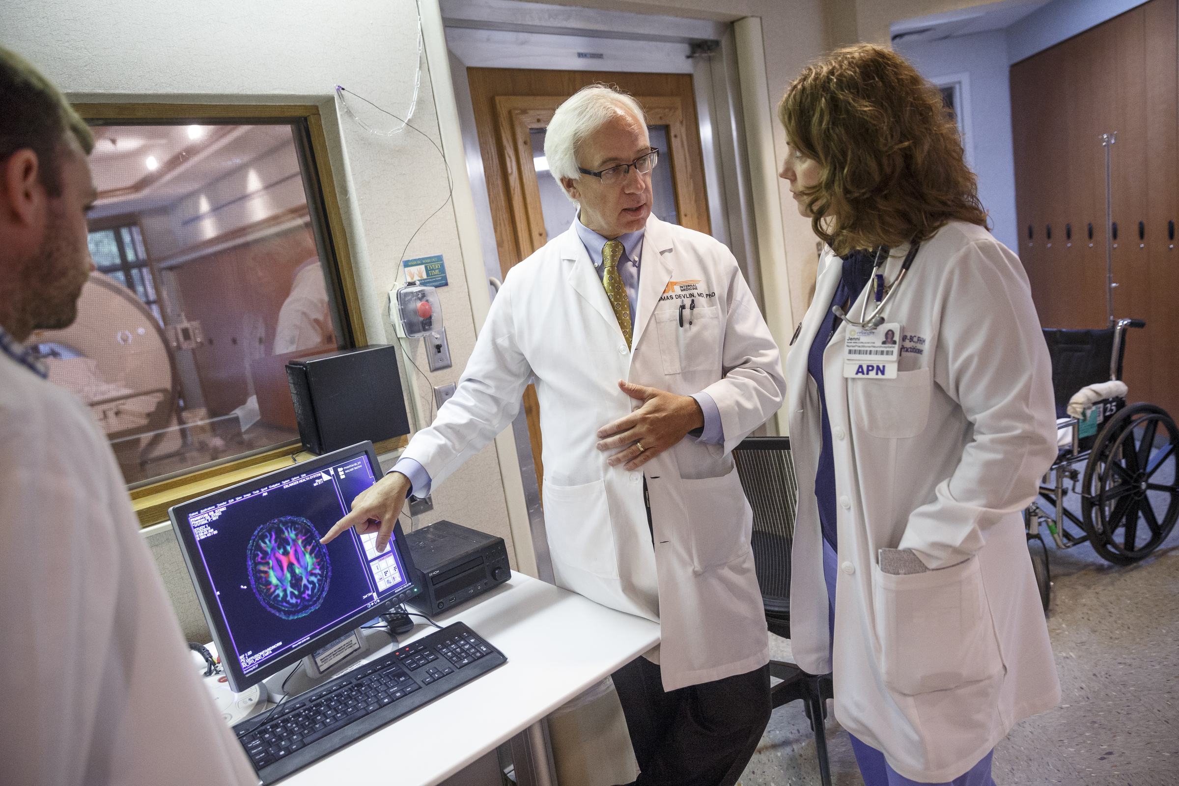 Dr. Thomas Devlin, center, talks with colleagues Dr. Brett Jennings, left, and neurohospitalist Jenni Smith about a patient's diffusion MRI and their possibility as a candidate for a clinical trial at Erlanger Hospital on Tuesday, Aug. 23, 2016, in Chattanooga, Tenn. Dr. Devlin is leading a clinical trial involving injecting stem cells into the brains of stroke victims.