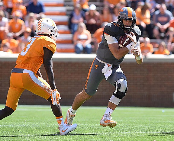 Quarterback Quinten Dormady (12) rushes between Marquill Osborne (3) and Rashaan Gaulden (7).  The University of Tennessee Orange/White Spring Football Game was held at Neyland Stadium in Knoxville on April 16, 2016.