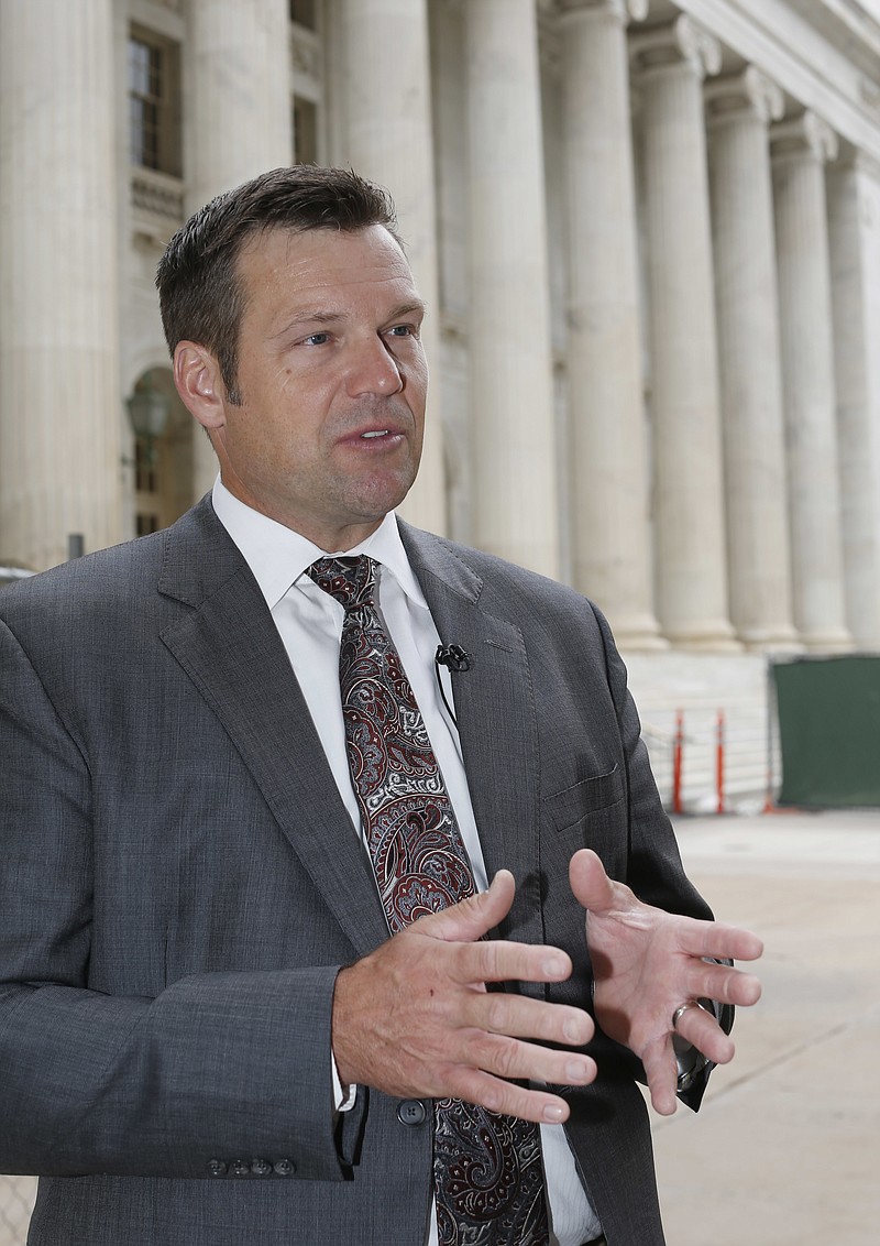
              Kansas Secretary of State Kris Kobach responds to questions outside the 10th U.S. Circuit Court of Appeals after delivering an argument in the legal fight over how the state of Kansas enforces its proof-of-citizenship requirement for voters who register at motor vehicle offices on Tuesday, Aug. 23, 2016 in Denver. The case was before the Appeals Court after a federal judge in May temporarily blocked Kansas from disenfranchising about 18,000 who registered to vote at motor vehicle offices without providing citizenship paperwork such as birth certificates or naturalization papers. (AP Photo/David Zalubowski)
            