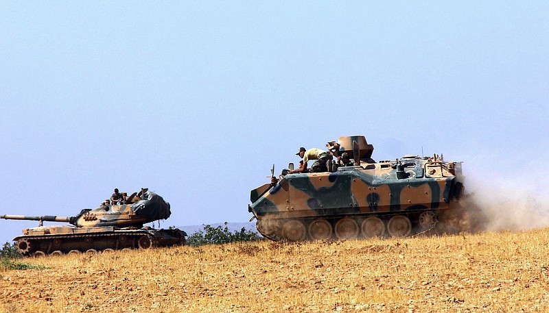 
              A Turkish army tank and an armored vehicle are stationed near the border with Syria, in Karkamis, Turkey, Tuesday, Aug. 23, 2016. Turkish media reports say Turkish artillery on Tuesday launched new strikes at Islamic State targets across the border in Syria, after two mortar rounds, believed to have been fired by the militants, hit the town of Karkamis, in Turkey's Gaziantep province. Hurriyet newspaper and other reports said the mortar rounds were fired from IS-held Jarablus, Syria.(IHA via AP)
            