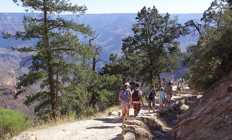
              FILE - In this July 27, 2015, file photo, hikers cross paths along Bright Angel Trail heading into and out of the Grand Canyon at Grand Canyon National Park, Ariz. Zika fears are leading some to book away from the Caribbean and Florida. The American Southwest, New England and Bermuda are providing a virus-free alternative, but destinations are hesitant to market themselves as such. (AP Photo/Ross D. Franklin, File)
            