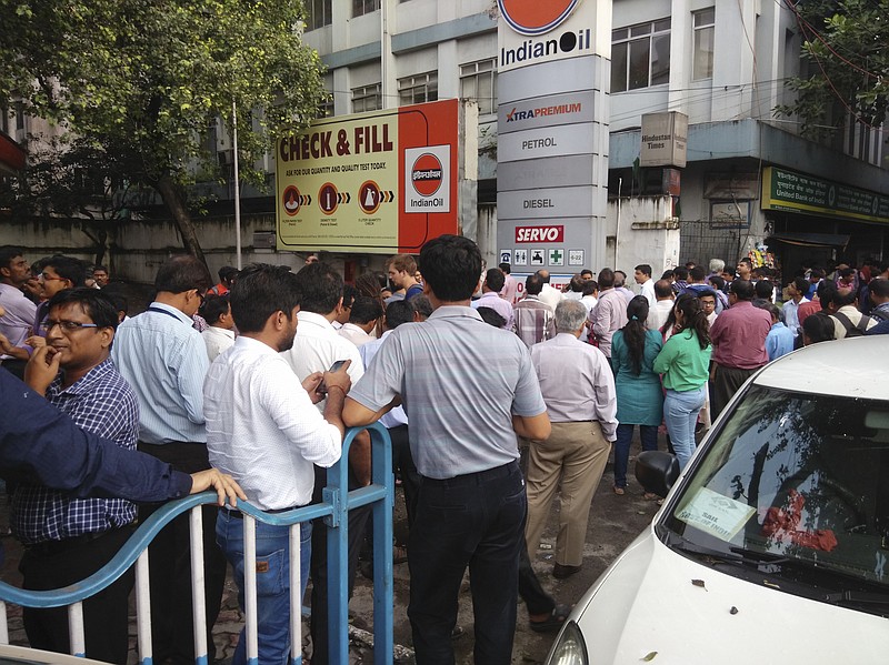 
              People stand outdoors after they rushed pout of their offices following tremors in Kolkata, India, Wednesday, Aug. 24, 2016. Officials say a powerful earthquake measuring a preliminary magnitude of 6.8 has shaken central Myanmar.(AP Photo/Bikas Das)
            