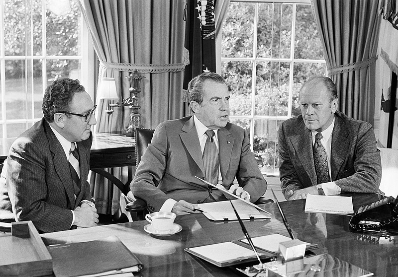 
              FILE - In this Oct. 13, 1973 file photo, then-vice presidential nominee Gerald R. Ford, right, listens as President Richard Nixon, accompanied by Secretary of State Henry Kissinger, speaks in the Oval Office of the White House in Washington. Overseas reaction to Nixon’s resignation in 1974 was mixed: The Soviets expressed worry about the future of detente. North Korea reacted brashly, calling Nixon’s exit the “falling out” of the “wicked boss” of American imperialists. South Vietnam put its forces on high alert because it feared the North Vietnamese would take advantage of the vulnerable U.S. political situation.  (AP Photo/Harvey W. Georges, File)
            
