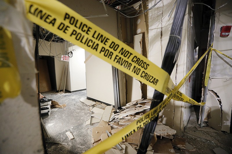 
              FILE - In this Tuesday, July 19, 2016, file photo, damage from a blast is shown in a hallway at El Centro College downtown campus in Dallas. According to officials, this site is where gunman Micah Johnson was killed by the blast after he killed five police officers wounding several in July during a protest. Johnson, an Army reservist, showed symptoms of post-traumatic stress disorder after returning home from Afghanistan in 2014 and sought treatment for anxiety, depression and hallucinations, according to newly released documents from the Veterans Health Administration. (AP Photo/Tony Gutierrez, File)
            