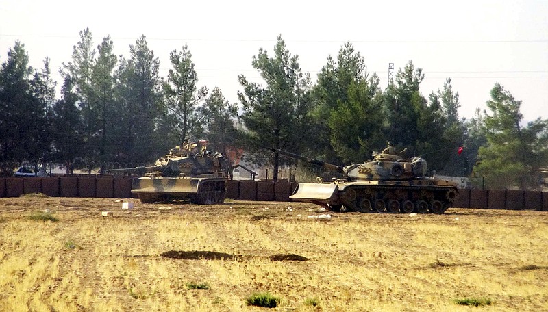 
              Turkish army tanks are stationed near the border with Syria, in Karkamis, Turkey, Wednesday, Aug. 24, 2016. Turkey's military launched an operation before dawn Wednesday to clear a Syrian border town from Islamic State militants, and a private Turkish TV station reported that a small number of Turkish special forces crossed into Syria as part of the operation. (DHA via AP)
            